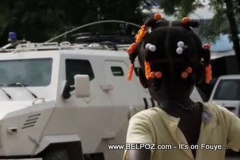 Haitian Girl Looking At A MINUSTAH Tank